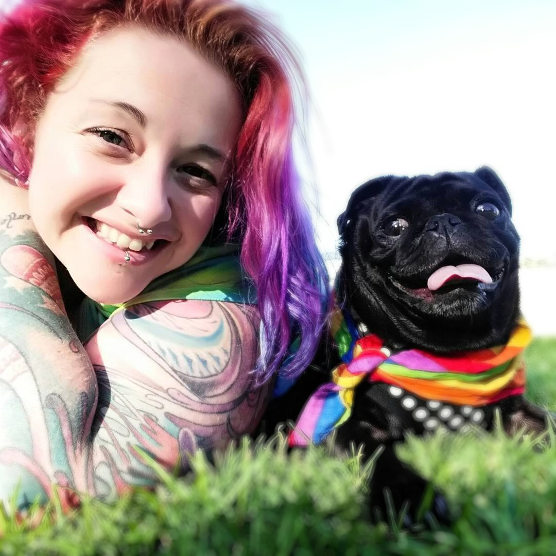 Mahlie Jewell and her pug friend, Skylar, lying on the grass in the sun