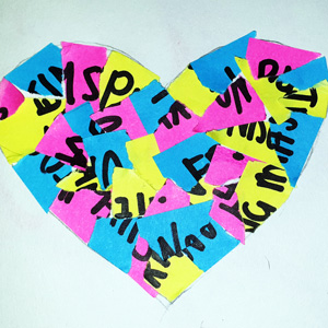 A paper heart made of many ripped up pieces of colourful paper